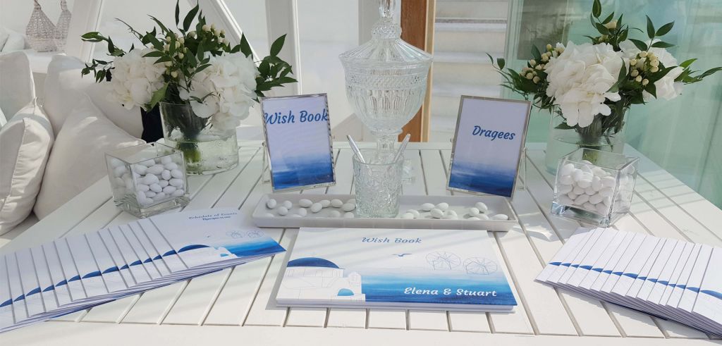 A white wooden table decorated with white flowers and a wishbook